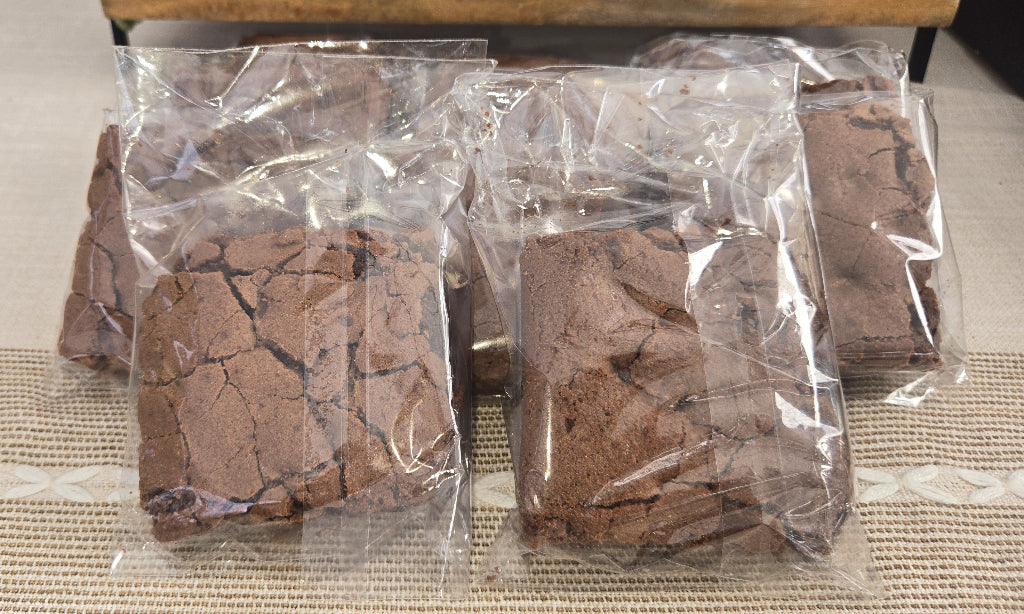 Brownies in clear plastic packaging on a textured surface