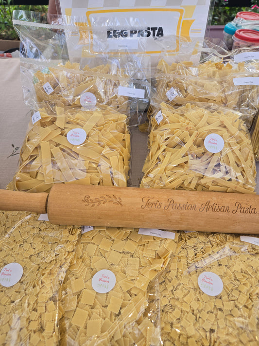Pasta packaging with a wooden rolling pin in the foreground