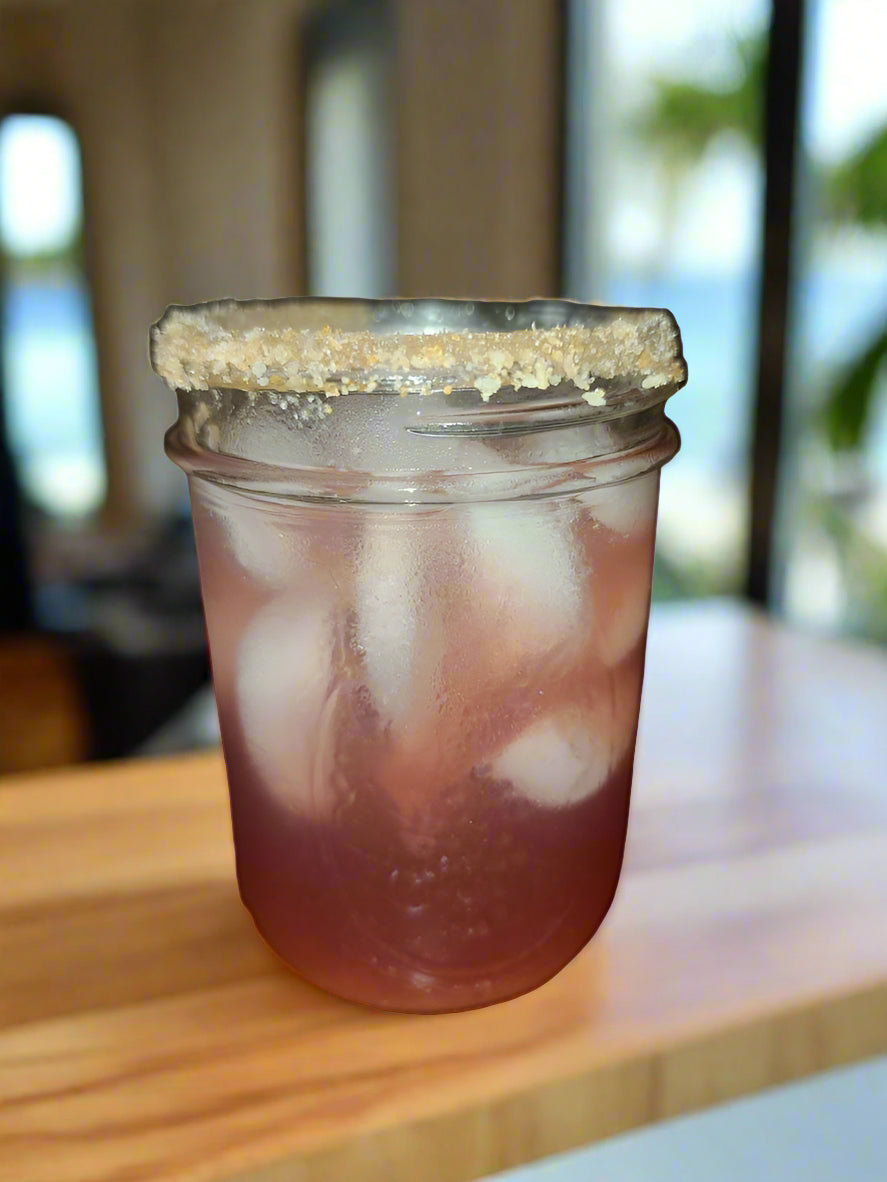 Trouble in Paradise Rimmer - Southern Sol cocktail glass on counter